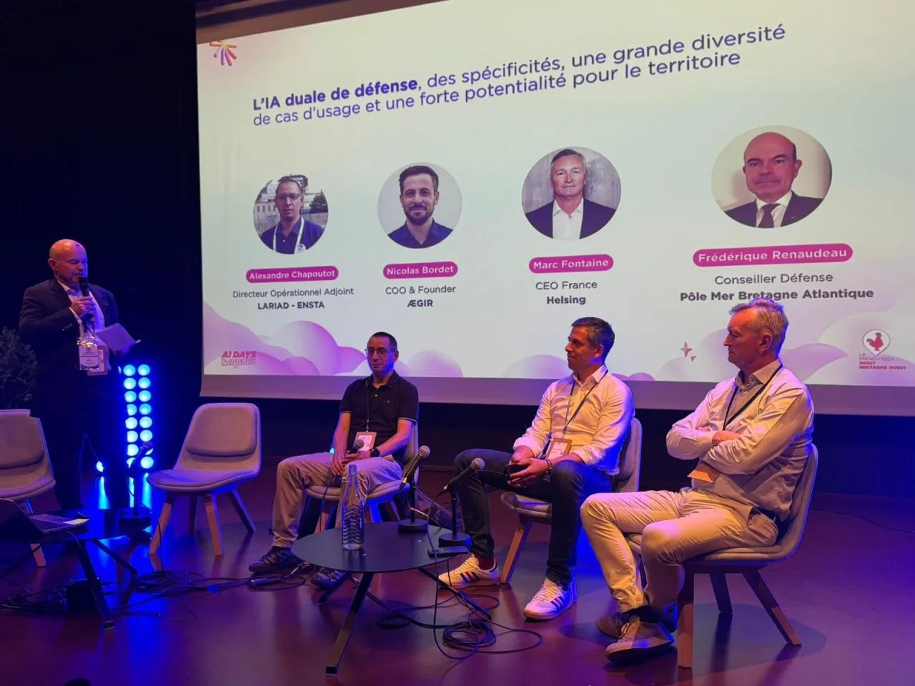 Four speakers seated on stage during the AI DAYS round table in Brest, with a screen above them showing the portraits of the participants and the title of the session.